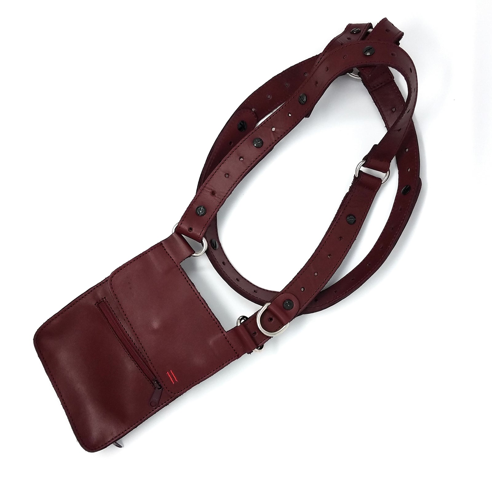 Side view of NiK Kacy Utility Holster Harness in Crimson, highlighting the structured leather design, secure wallet compartment, and modular strap adjustments.
