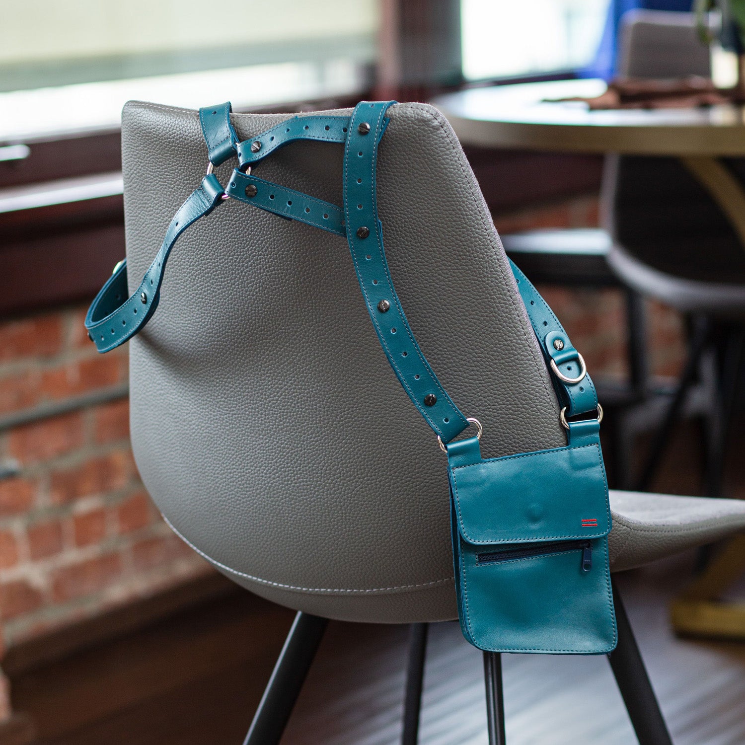 Custom-secured NiK Kacy Modular single holster bag in Teal, fastened with engineered screws for durability and security.