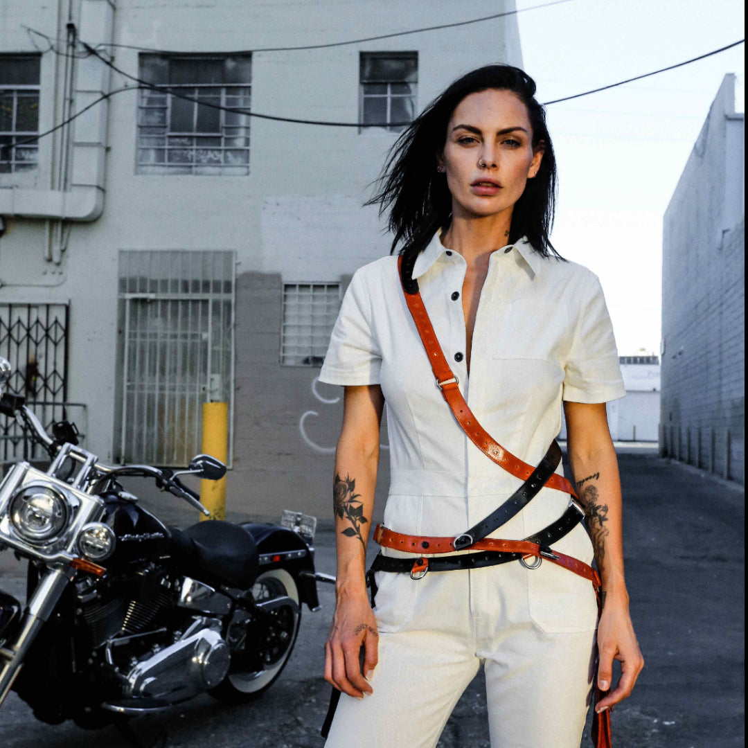 NiK Kacy's genderfree holster bags are modular in design so you can mix and match to create your own custom holster harness design. Seen here, model Teela LaRoux is wearing two holsters (1 black and 1 orange) combined together to create this apocalyptic look.