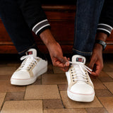 Model wearing the DapperBoi ❤️ S25 Low-Tops, a gender-inclusive sneaker designed for all identities, made with 100% vegan leather and handmade in Italy. (Image courtesy of Shay Studios and Dapper Boi).